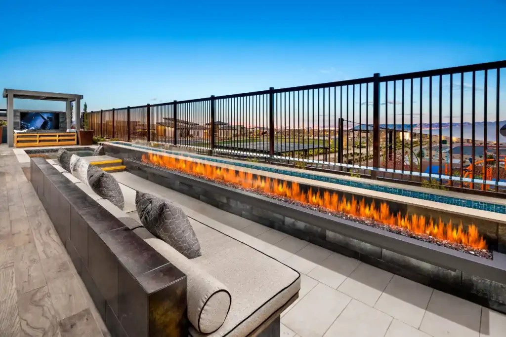 Outdoor living by Edgewater Custom Pools – Peak Cascade Modern Sunken Patio Twilight